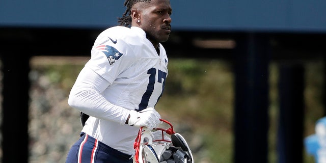 New England Patriots wide receiver Antonio Brown carries his helmet during an NFL football practice in Foxborough, Mass. The Patriots released Brown on Friday, Sept. 20, 2019. (AP Photo/Steven Senne, File)