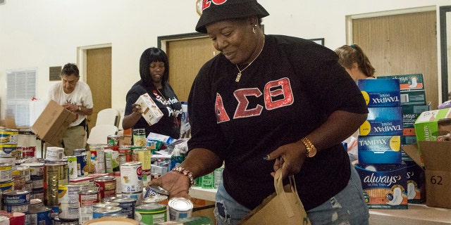 Volunteer Diane Alexander, 57, organizing donated goodsin Miami on Tuesday. (AP Photo/Ellis Rua)