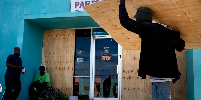 Hurricane Dorian, Category 5 storm, bears down on Bahamas while islands hunker down, 'taking no chances' 2 Workers board up a shop's window front as they make preparations for the arrival of Hurricane Dorian, in Freeport, Bahamas.