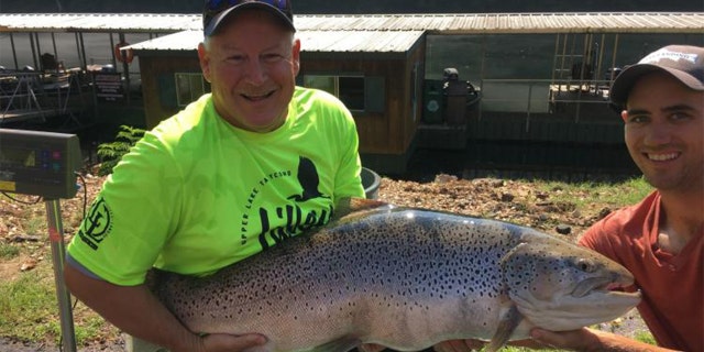 Bill Babler, left, holding the new state-record brown trout with his friend, Ryan Titus. The fish was caught Wednesday at Lake Taneycomo, weighing in at 40 pounds, 6 ounces.