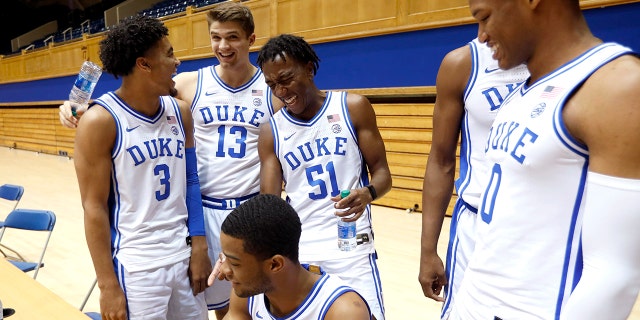 Duke's Tre Jones (3) laughs with Joey Baker (13), Mike Buckmire (51), Cassius Stanley (2), bottom left, and Wendell Moore (0) during an NCAA college basketball media day at Cameron Indoor Stadium in Durham, N.C., Monday, Sept. 23, 2019. (Ethan Hyman/The News & Observer via AP)