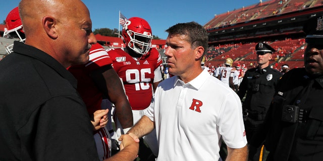 Rutgers head coach Chris Ash, center, shakes hands with head coach Steve Addazio of Boston College after an NCAA college football game on Saturday, Sept. 21, 2019, in Piscataway, N.J. Boston College won, 30-16. (Chris Faytok/NJ Advance Media via AP)