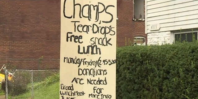 Champale Anderson has a sign in front of his house promoting free snacks offered by neighborhood kids.