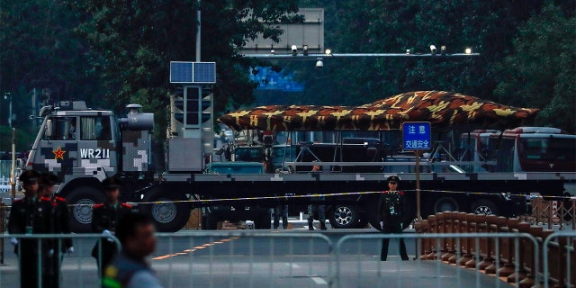 A Chinese military vehicle possibly carrying a drone passing along the Jianguomenwai Avenue last weekend during a rehearsal for the 70th anniversary of Communist China, in Beijing. (AP Photo/Andy Wong)