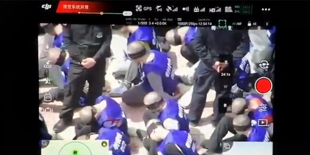This screenshot purportedly shows hundreds of prisoners shackled and blindfolded who are believed to be from China's minority Uighur Muslims, reports claim.