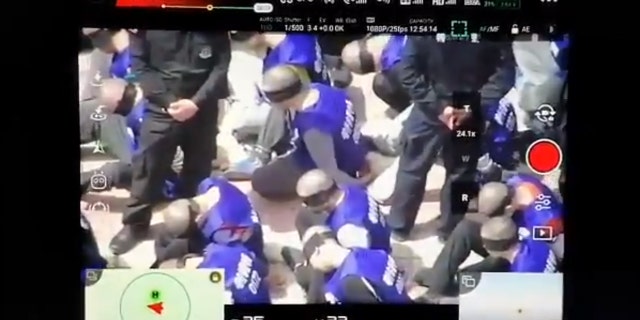 This screenshot purportedly shows hundreds of prisoners shackled and blindfolded who are believed to be from China's minority Uighur Muslims, reports claim.