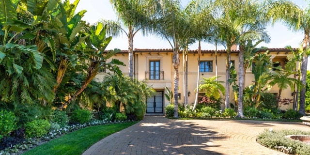 The villa-style home, which is "guard gated" in a “unique, prestigious” location, measures nearly 8,000 square feet and sits on 0.75 acres.