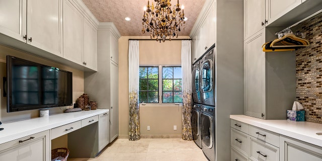 Fancy features include a grand two-story foyer, sweeping staircase, a “top shelf” suite of appliances in the kitchen, home theater, a “tech-bar” room and fireplaces throughout.