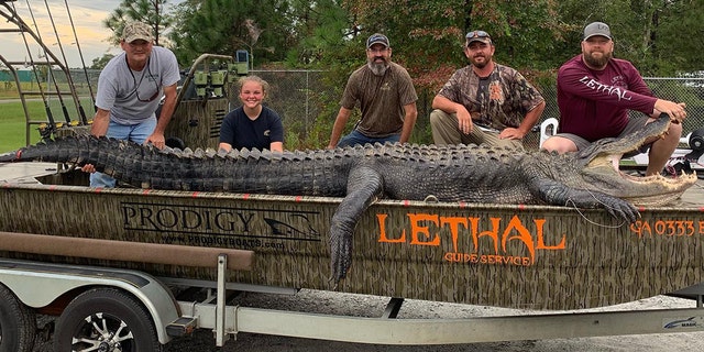 Derrick and Shelby Snelson were thrilled to catch a "monster" alligator during the girl's first gator hunting trip.