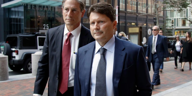 Devin Sloane, right, arrives at Boston federal court for sentencing Thursday. (AP Photo/Elise Amendola)