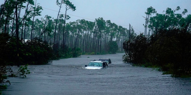 Cars sit submerged in water from Hurricane Dorian in Freeport, Bahamas, Tuesday, Sept. 3, 2019.