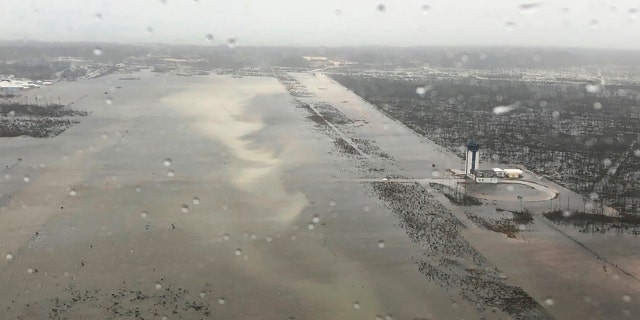 This Monday, Sept. 2, 2019 photo released by the U.S. Coast Guard Station Clearwater, shows flooding on the runway of the Marsh Harbour Airport in the Bahamas.