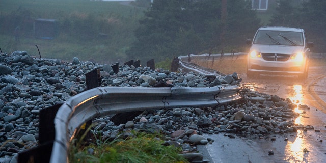 A guard rail was damaged by powerful waves that drove rocks on shore in Cow Bay, Nova Scotia, on Saturday, Sept. 7, 2019.