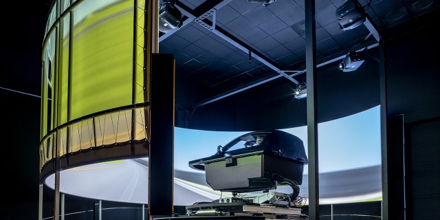 Ford engineers are testing electric vehicle performance in a simulator.