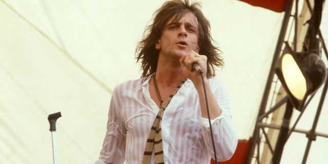 Eddie Money performing on stage.