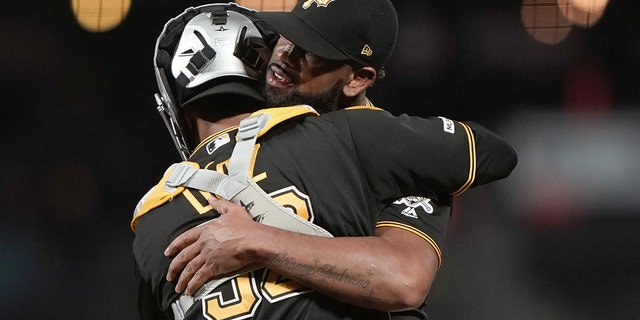 September 9, 2019; San Francisco, California, United States; Pittsburgh Pirates receiver Elias Diaz (32) holds relief thrower Felipe Vazquez (73) after coming out from behind and defeating the San Francisco Giants at Oracle Park. Mandatory Credit: Stan Szeto-USA TODAY Sports - 13335198