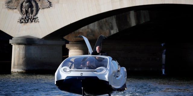 SeaBubbles co-founder Sweden's Anders Bringdal stands onboard a SeaBubble on the river Seine, Wednesday Sept. 18, 2019 in Paris. (AP Photo/Francois Mori)
