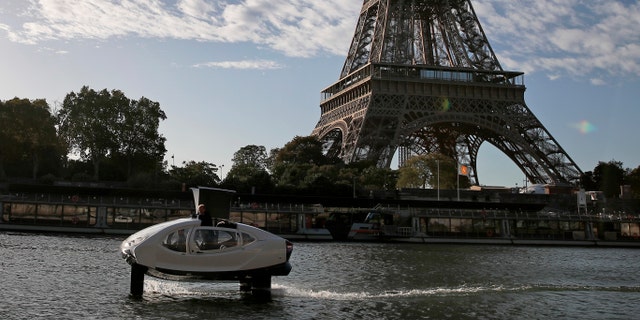 SeaBubbles co-founder Sweden's Anders Bringdal stands onboard a SeaBubble by the Eiffel Tower on the river Seine, Wednesday Sept. 18, 2019 in Paris.