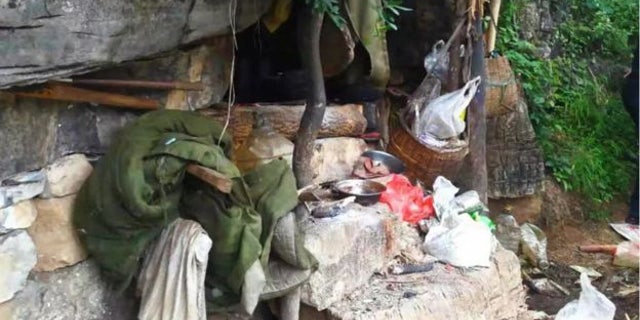 The drones spotted household rubbish strewn around the cave where Song JIang was found hiding after 17 years on the lam.