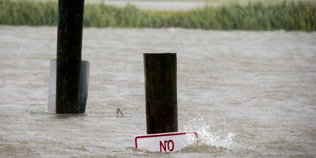 A sign at the Lazaretto Creek boat ramp as is nearly underwater at high tide as Hurricane Dorian makes its way up the east coast, Wednesday, Sept. 4, 2019, toward Tybee Island, Ga.
