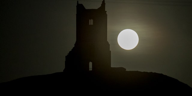The full Harvest moon rises over the ruins of St Michael's Church, a scheduled monument on the top of Burrow Mump on Oct. 5, 2017 in Somerset, England - File Photo.
