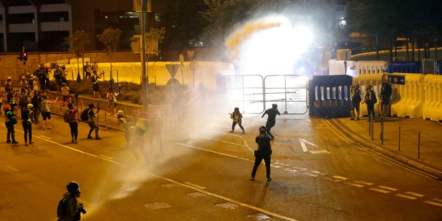 Police fire water cannon on protestors in Hong Kong Saturday. (AP Photo/Vincent Thian)