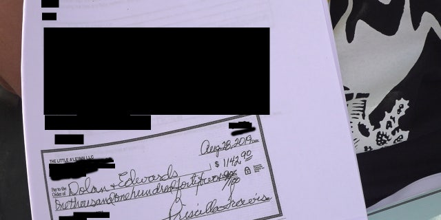 A signed copy of a check for one of the insurance policies for AlienStock.