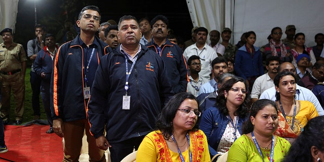 Indian Space Research Organization (ISRO) employees react as they listen to an announcement by organizations's chief Kailasavadivoo Sivan at its Telemetry, Tracking and Command Network facility in Bangalore, India, Saturday, Sept. 7, 2019. India's space agency said it lost touch Saturday with its Vikram lunar lander as it aimed to land on the south pole of the moon and deploy a rover to search for signs of water. (AP Photo/Aijaz Rahi)