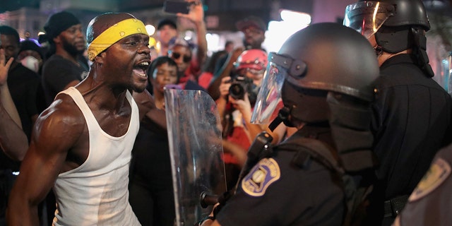 Demonstrators confront police while protesting the acquittal of former St. Louis Police Officer Jason Stockley in St. Louis in September 2017.