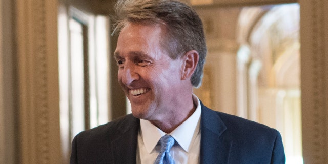 UNITED STATES - JULY 09: Sen. Doug Jones, D-Ala., left, talks with former Sen. Jeff Flake, R-Ariz., talks with reporters after the Senate Policy luncheons in the Capitol on Tuesday, July 09, 2019. (Photo By Tom Williams/CQ Roll Call)