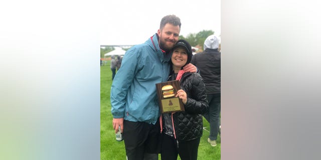 Sam's parents Andy and Kelsey Quarberg, seen here with an award commemorating the burger's third-place win at the Twin Cities Burger Battle. Kelsey birthed their son Sam just seven hours after first eating the burger.