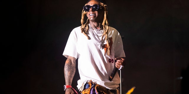 In this Saturday, Sept. 7, 2019 photo, Lil Wayne performs during his fifth annual Lil WeezyAna Fest at the UNO Lakefront Arena grounds in New Orleans. Lil Wayne, Meek Mill and Travis Scott headlined the event. A crowd stampede injured several people attending a New Orleans festival organized by rapper Lil Wayne.