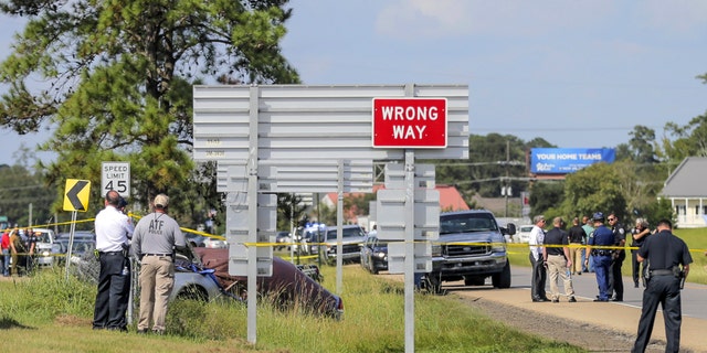 Authorities surround the scene of the Friday shootout in Mandeville, Louisiana (David Grunfeld / The Advocate via AP)