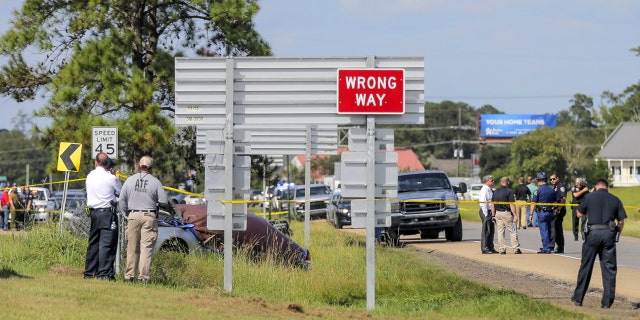 Authorities surround the scene of the Friday shootout in Mandeville, Louisiana (David Grunfeld / The Advocate via AP)