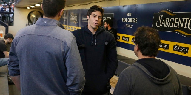 Milwaukee Brewers' Christian Yelich, center, talks with general manager David Stearns, left, and owner Mark Attanasio, right, before a baseball game against the Pittsburgh Pirates, Sunday, Sept. 22, 2019, in Milwaukee. (AP Photo/Aaron Gash)