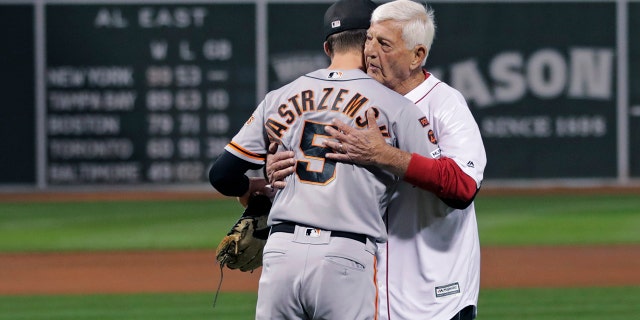 Boston Red Sox great and Hall of Famer Carl Yastrzemski, right, embraces his grandson San Francisco Giants right fielder Mike Yastrzemski during a ceremony prior to a baseball game at Fenway Park in Boston, Wednesday, Sept. 18, 2019. (AP Photo/Charles Krupa)