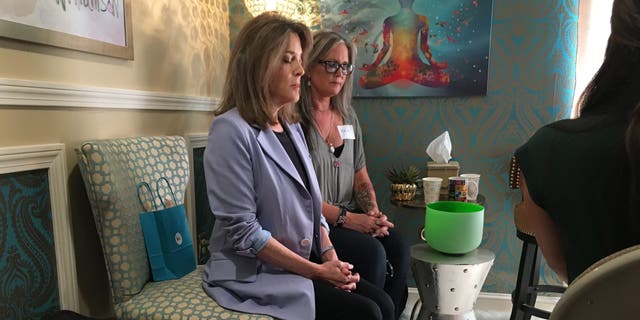 Democratic presidential candidate Marianne Williamson leads a mediation in Manchester, NH on Monday September 9, 2019