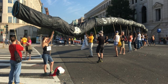 Sept. 23, 2019: Protesters hoist up a fake pipeline near Union Station in Washington, D.C. (Tyler Olson/Fox News)