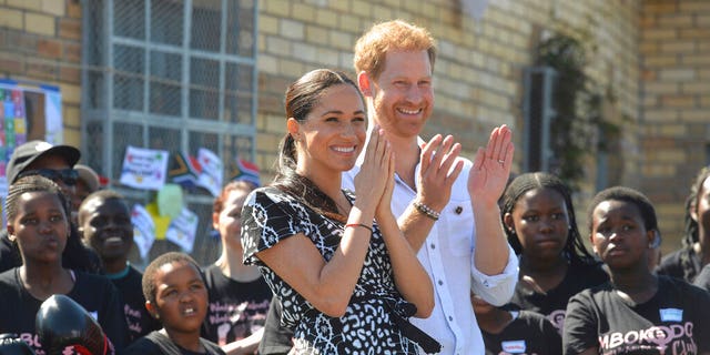 Prince Harry and Meghan Markle greet youths on a visit to the Nyanga Methodist Church in Cape Town, South Africa, Monday, Sept. 23, 2019. (Courtney Africa / Africa News Agency via AP, Pool)