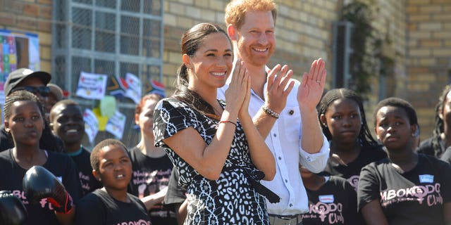 Prince Harry and Meghan Markle greet youths on a visit to the Nyanga Methodist Church in Cape Town, South Africa, Monday, Sept. 23, 2019. (Courtney Africa / Africa News Agency via AP, Pool)