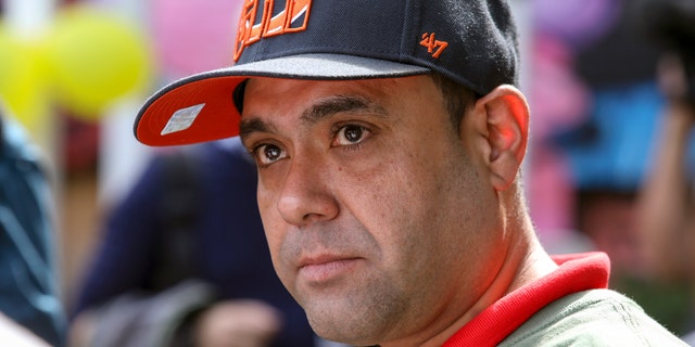 Miguel Perez Jr. listens to a supporter speak at a press conference in Chicago on Tuesday. (AP Photo / Teresa Crawford)