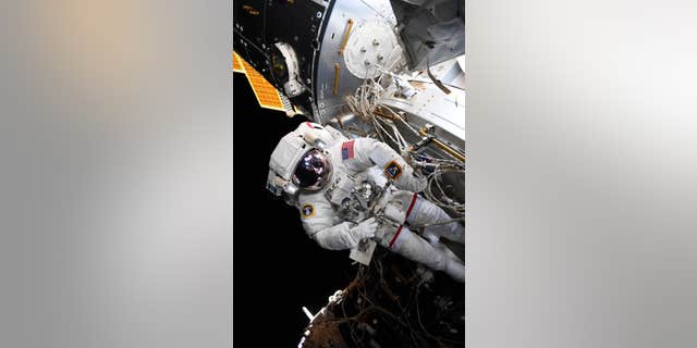 NASA astronaut Nick Hague sporting the Artemis logo during a spacewalk on Aug. 22. (NASA)