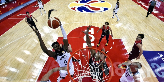 Jaylen Brown, left, of the US fights for the ball with Japan's Rui Hachimura during the Basketball World Cup Group E game between US and Japan in Shanghai, China, Thursday, Sept. 5, 2019. (Hector Retamal/Pool Photo via AP)