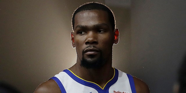 FILE - This is a Sept. 24, 2018, file photo showing then-Golden State Warriors' Kevin Durant posing for photos during media day at the NBA basketball team's practice facility in Oakland, Calif. (AP Photo/Jeff Chiu, File)
