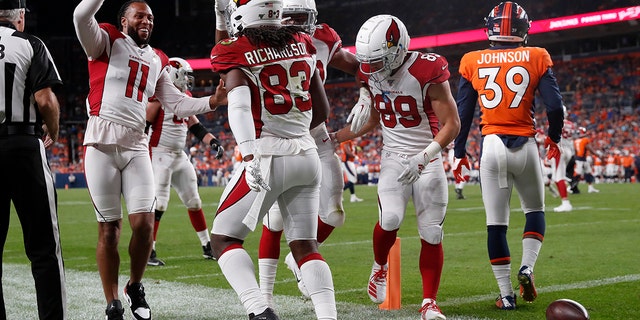 Arizona Cardinals wide receiver A.J. Richardson (83) celebrates his touchdown with wide receiver Larry Fitzgerald (11) during the second half of an NFL preseason football game against the Denver Broncos, Thursday, Aug. 29, 2019, in Denver. (AP Photo/David Zalubowski)