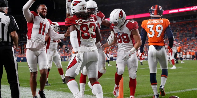 Arizona Cardinals wide receiver A.J. Richardson (83) celebrates his touchdown with wide receiver Larry Fitzgerald (11) during the second half of an NFL preseason football game against the Denver Broncos, Thursday, Aug. 29, 2019, in Denver. (AP Photo/David Zalubowski)
