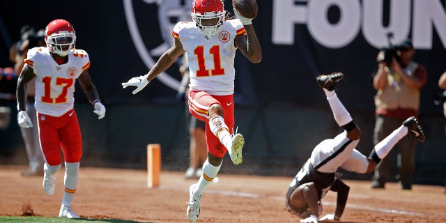 Kansas City Chiefs wide receiver Demarcus Robinson (11) celebrates after scoring a touchdown as teammate Mecole Hardman (17) looks on during the first half of an NFL football game against the Oakland Raiders Sunday, Sept. 15, 2019, in Oakland, Calif. At right is Oakland Raiders cornerback Gareon Conley. (AP Photo/Ben Margot)