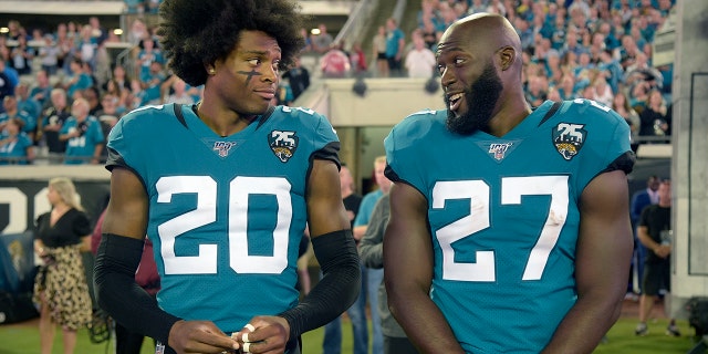 Jacksonville Jaguars cornerback Jalen Ramsey (20) talks to running back Leonard Fournette (27) before an NFL football game against the Tennessee Titans Thursday, Sept. 19, 2019, in Jacksonville, Fla. (AP Photo/Phelan M. Ebenhack)