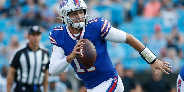 In this Aug. 16, 2019, file photo, Buffalo Bills quarterback Josh Allen (17) runs out of the pocket against the Carolina Panthers during the first half an NFL preseason football game, in Charlotte, N.C. (AP Photo/Brian Blanco, File)