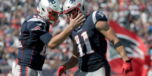 New England Patriots quarterback Tom Brady, left, celebrates his touchdown pass to Julian Edelman, right, in the first half of an NFL football game against the New York Jets, Sunday, Sept. 22, 2019, in Foxborough, Mass. (AP Photo/Elise Amendola)